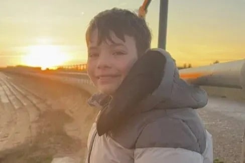 Family pay touching tribute to boy, 13, killed while riding scooter as two men arrested over fatal collision